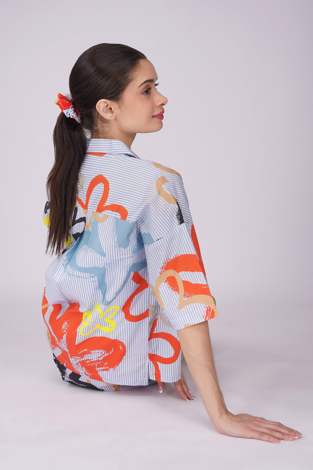 Model wearing a colorful pop art floral shirt, showcasing a stylish womens cotton shorts set for lounging.