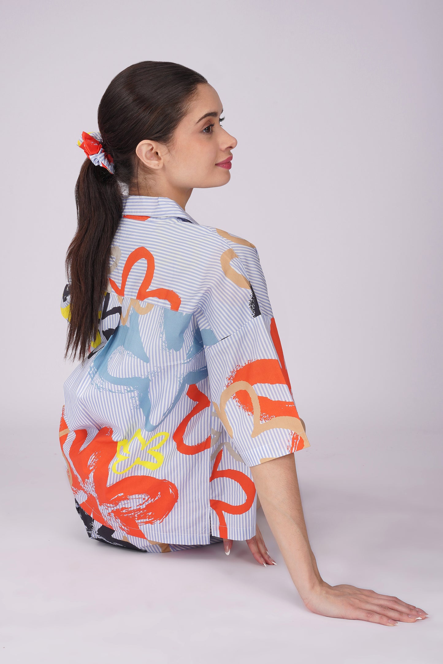 Model wearing a colorful pop art floral shirt, showcasing a stylish womens cotton shorts set for lounging.